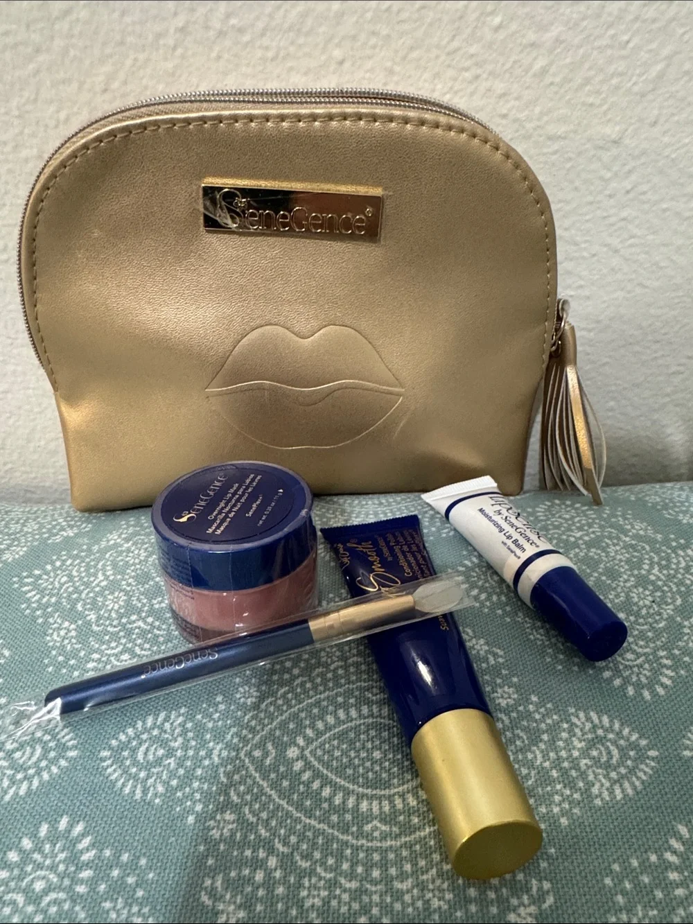 SeneGence Gold Makeup Pouch with lip mask, applicator, lip polish, and lip balm